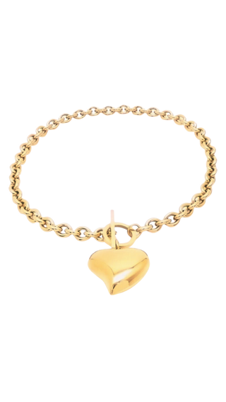 Gold bracelet with a heart-shaped pendant on a white background
