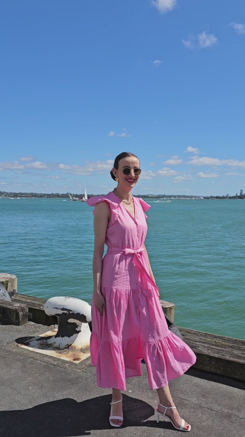 Valencia Pink Linen Tiered Midi Dress in the beach | Alma Gray